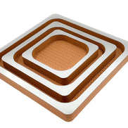 Three nested copper-toned leather squares, mirror-polished tops stepping down from the 41 cm outer tray to the 21 cm centre