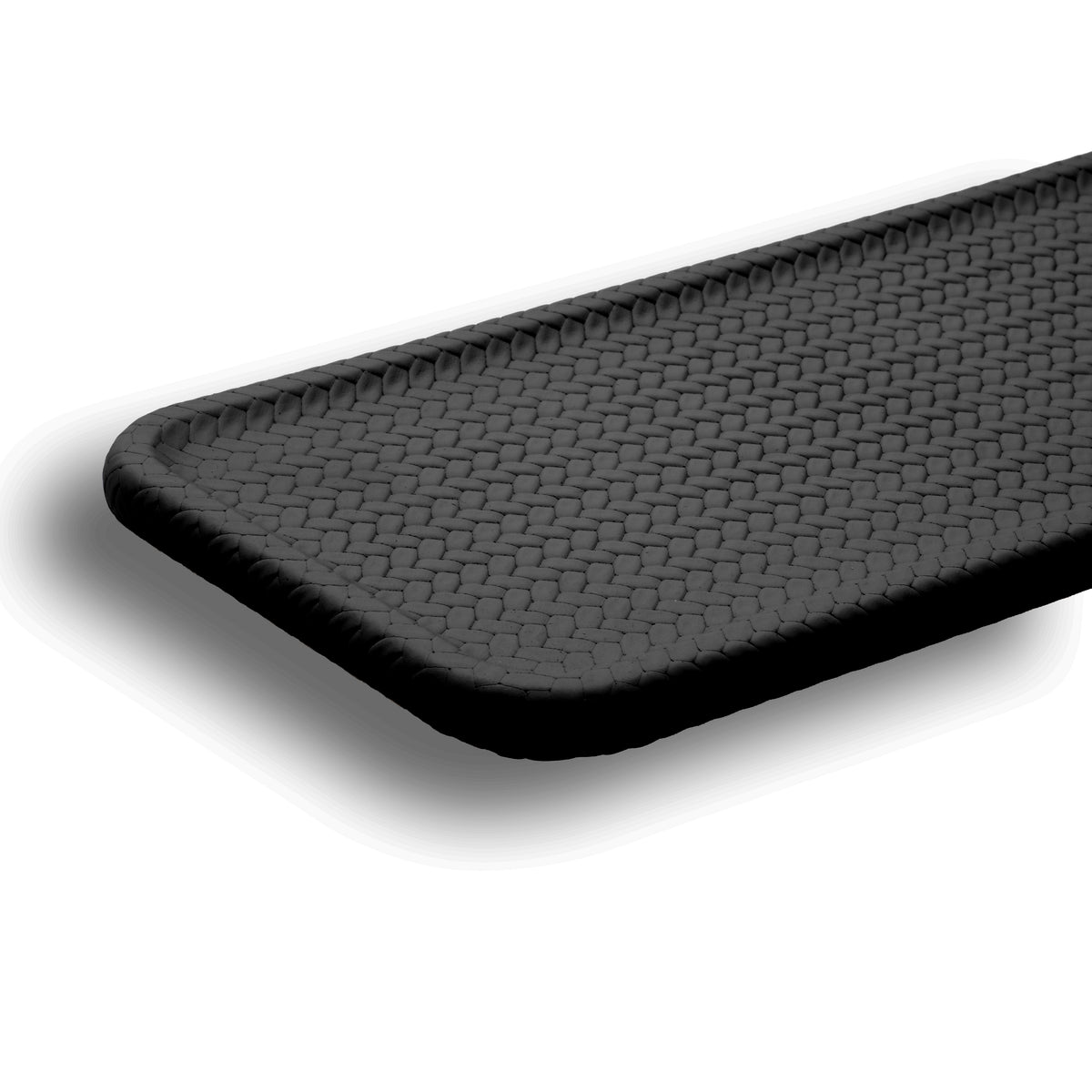 Black placemat seen along its length, the raised braided edge framing the flat woven field
