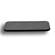 Black placemat at a low angle, the woven emboss dense across the whole 50 cm face