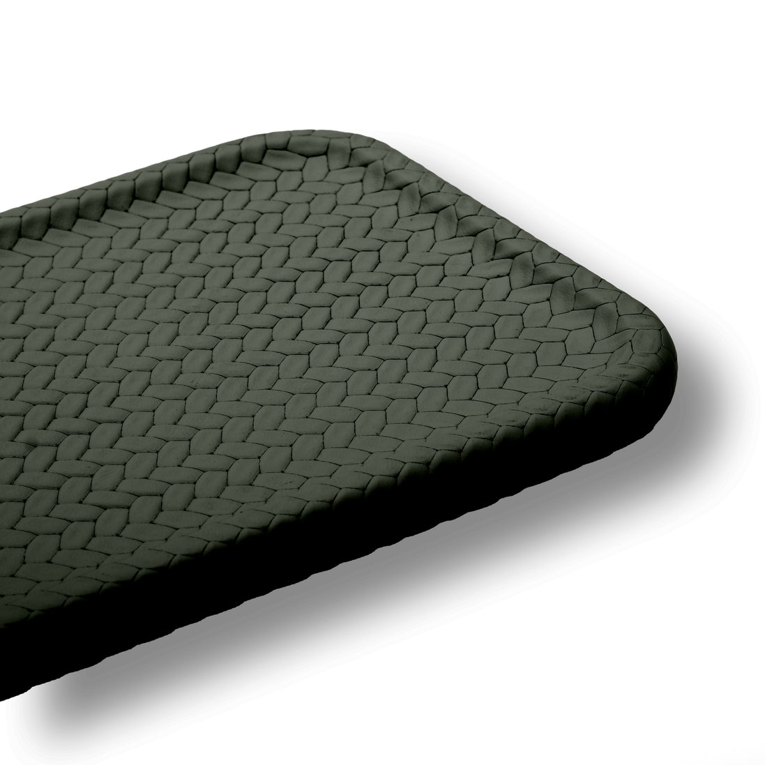 Macro of the khaki placemat corner, the woven-embossed leather cells and the softly rounded radius