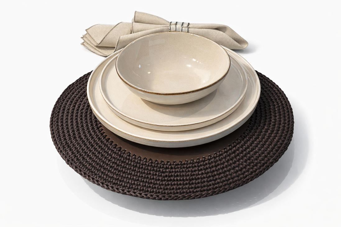 The 36 cm brown placemat laid with three cream ceramics, its cord border showing past the plate rim