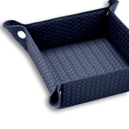 Navy valet tray at close range, woven-embossed leather running up the full 6 cm side wall