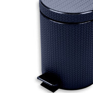 Close on the navy bin's shoulder and lid, woven-embossed full-grain leather filling the frame