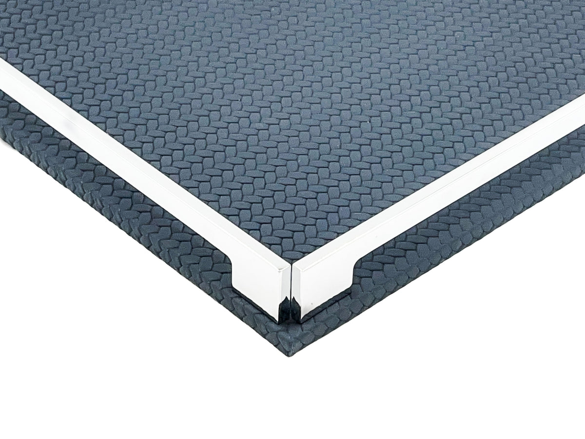 Corner of the navy 37 cm tray close up, two steel rails meeting at the polished bracket over the leather weave