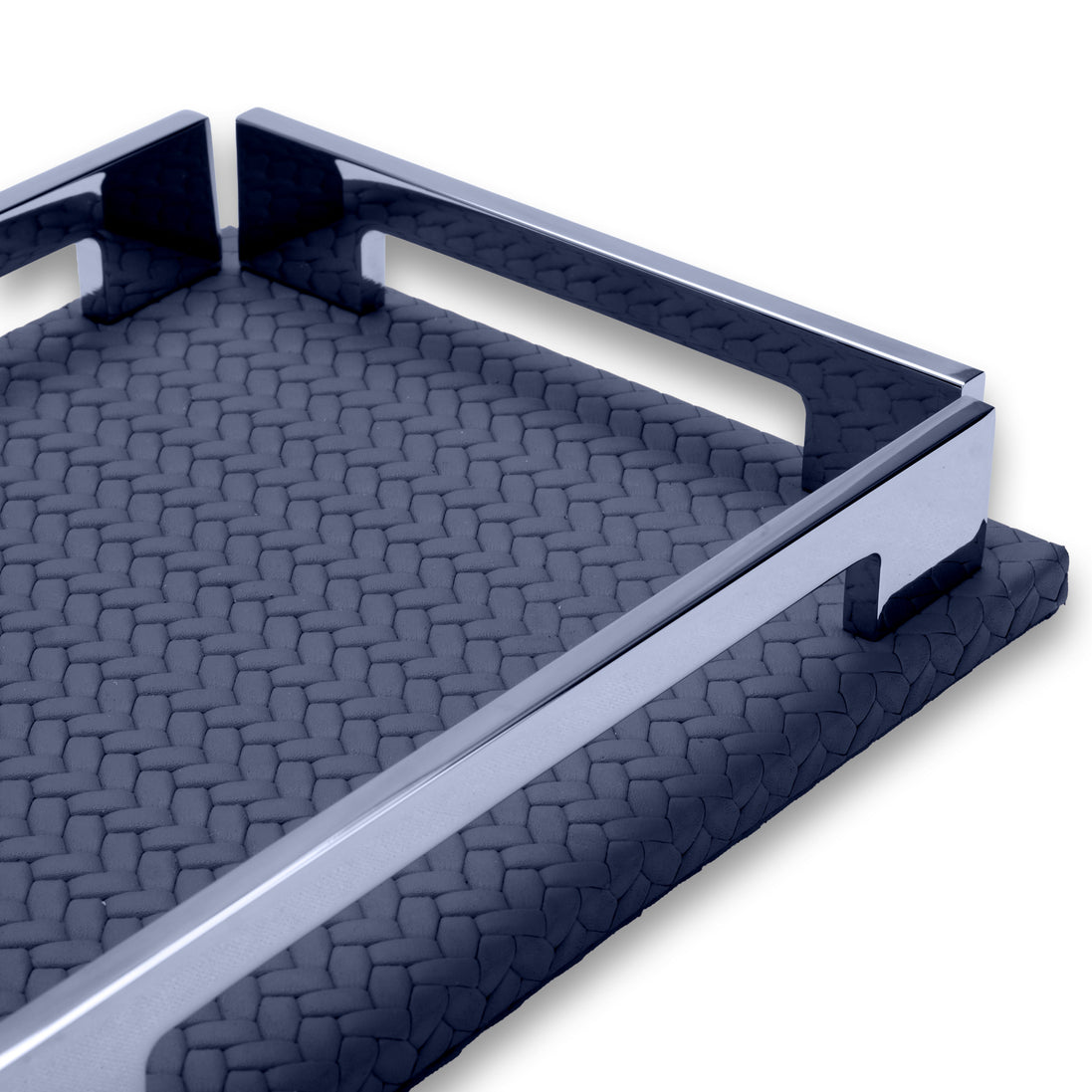 Polished rail and cut notch along the navy tray's long edge, woven-embossed leather stretching behind