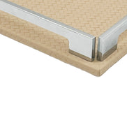Close on a corner of the beige 30 cm tray, polished steel bracket seated on woven-embossed full-grain leather