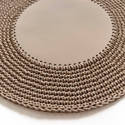 Close on the sand placemat, whipstitch teeth joining the leather centre to the crocheted cord rows