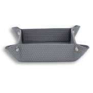 Grey leather tray seen level, the plait coarse on the walls above a finer floor weave