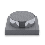 Grey coaster set, the base's woven leather standing wider than the steel-banded stack