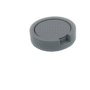 Grey coaster stack seen more from the side, woven-embossed leather rim around the Ø 10 cm discs