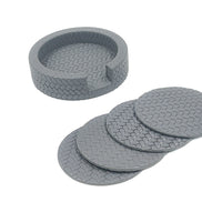 The grey holder empty with its four Ø 10 cm coasters fanned out alongside