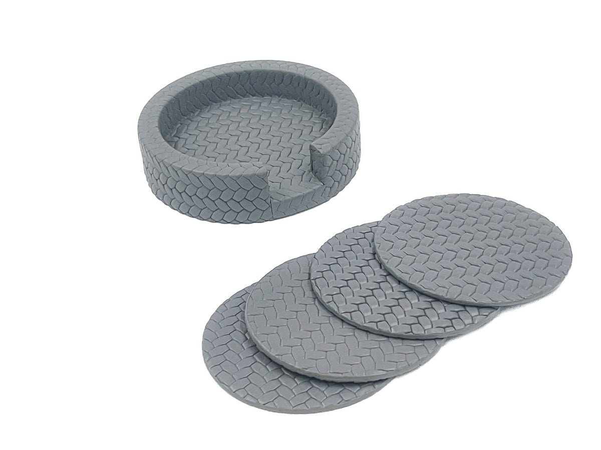 The grey holder empty with its four Ø 10 cm coasters fanned out alongside