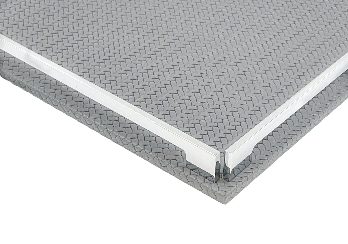 Corner of the grey 37 cm tray close up, woven-embossed full-grain leather at full scale beside the polished rail