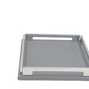 Grey 25 × 25 cm tray face on, handle slot cut through the steel rail above the leather weave