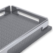The grey tray's long rail from low down, notch cut into the leather base, weave running to the far corner