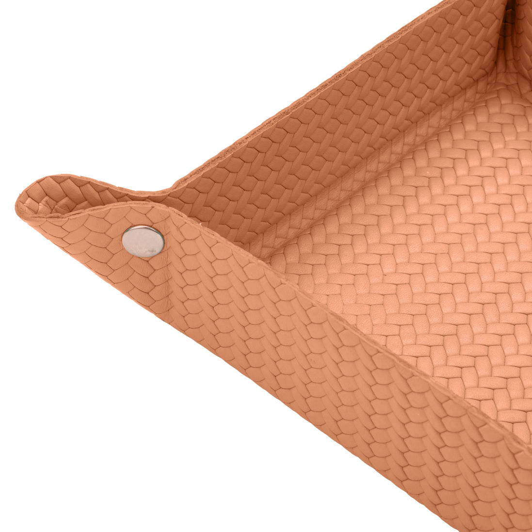 Close on a corner of the tan valet tray, press stud and woven-embossed full-grain leather at full scale