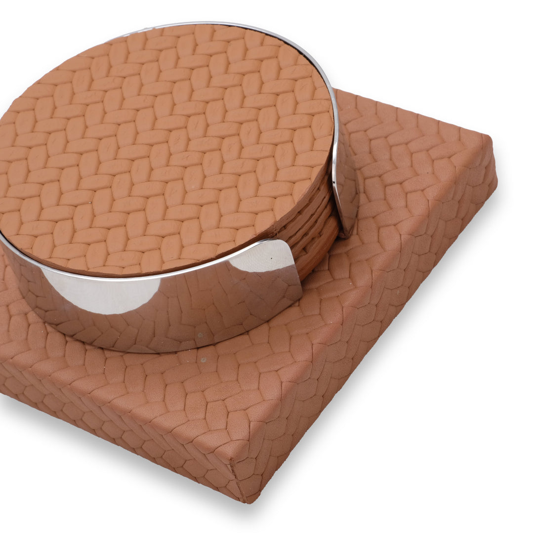 Close from above on the tan coaster set, the top disc's woven emboss and the polished steel band at full scale