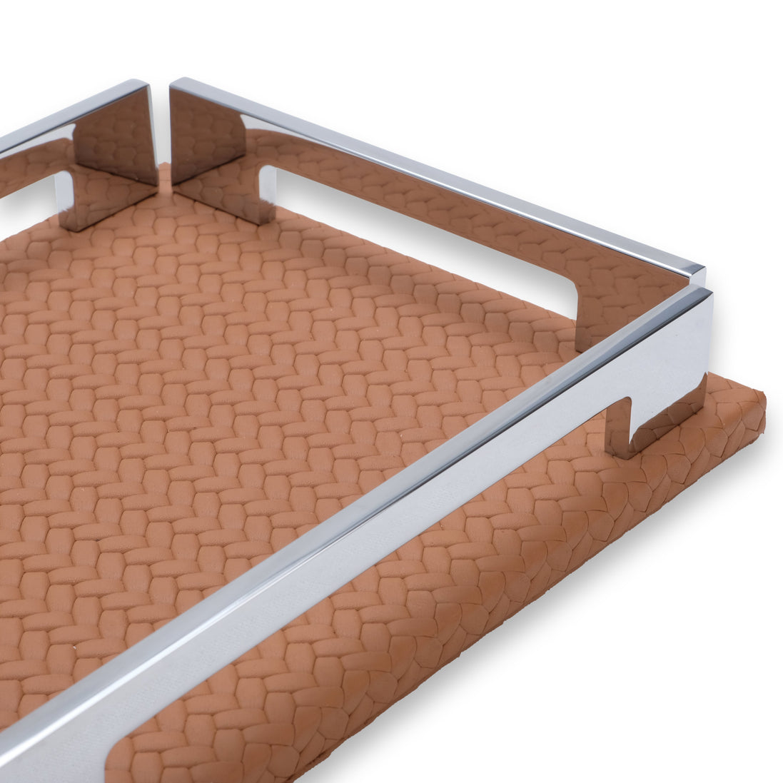 Close along the tan tray's long side, polished rail and side notch, woven-embossed leather receding