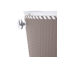 Close on one steel ring handle of the mink bucket, whip-stitched rim and woven leather at full scale