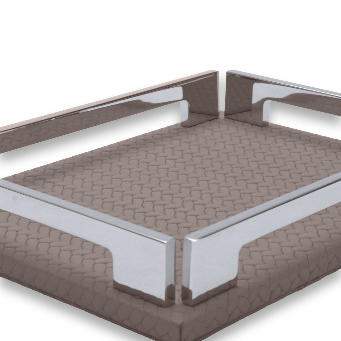 Corner of the mink tray, two polished brackets against the full-grain leather weave