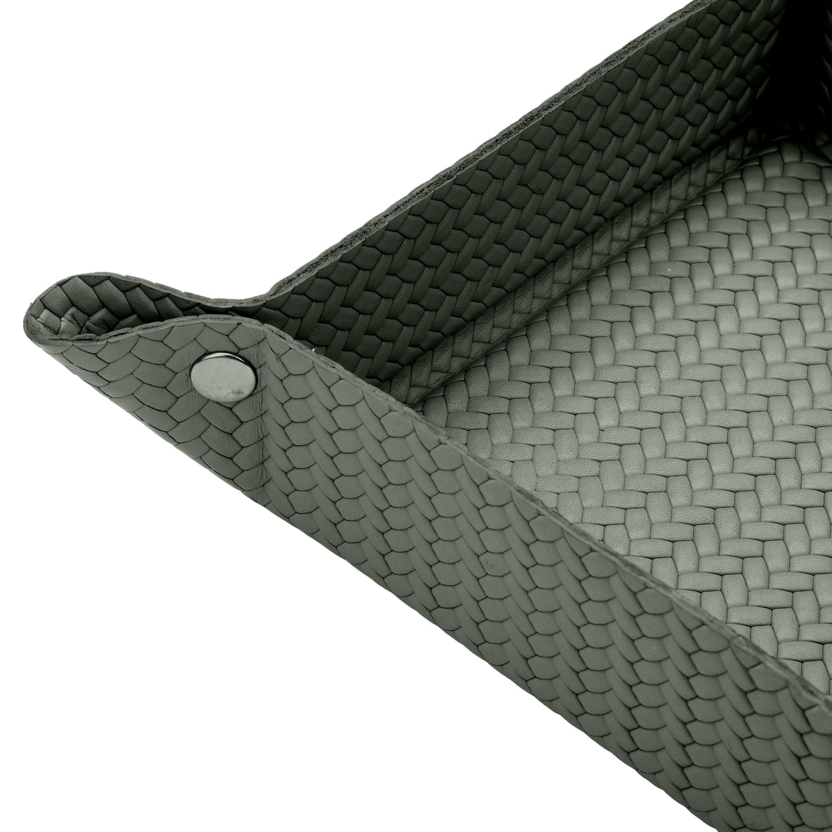Close on the khaki tray corner, one press stud and the woven-embossed full-grain leather at full scale