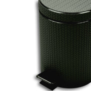 Close on the khaki bin, woven-embossed leather filling the frame above the chrome pedal plate