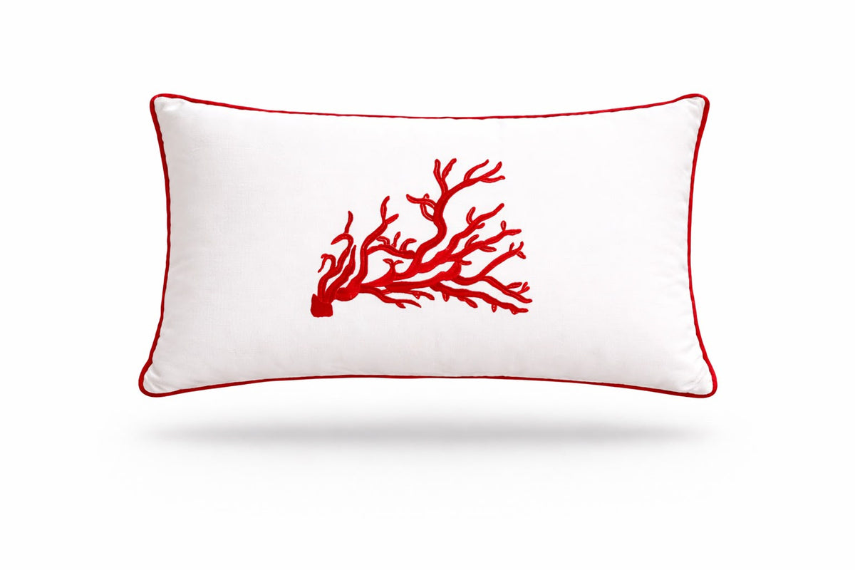 Red coral embroidered on the white 35 x 55 cm rectangular cushion, red piping around the edge