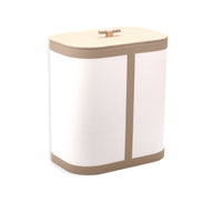 Sand-toned leather trim on the canvas hamper, a small leather toggle set into the 45 cm wide lid
