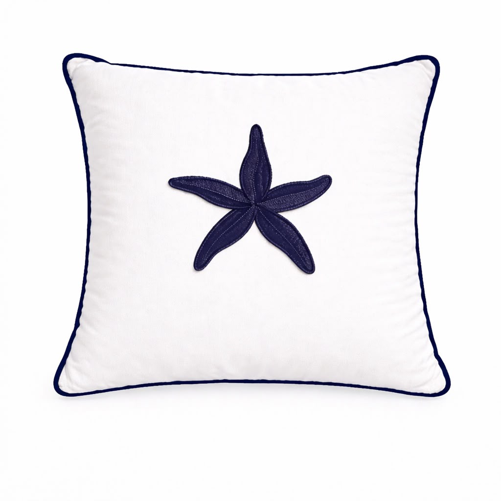 Navy starfish embroidered at the centre of a white 45 x 45 cm outdoor cushion, navy piping