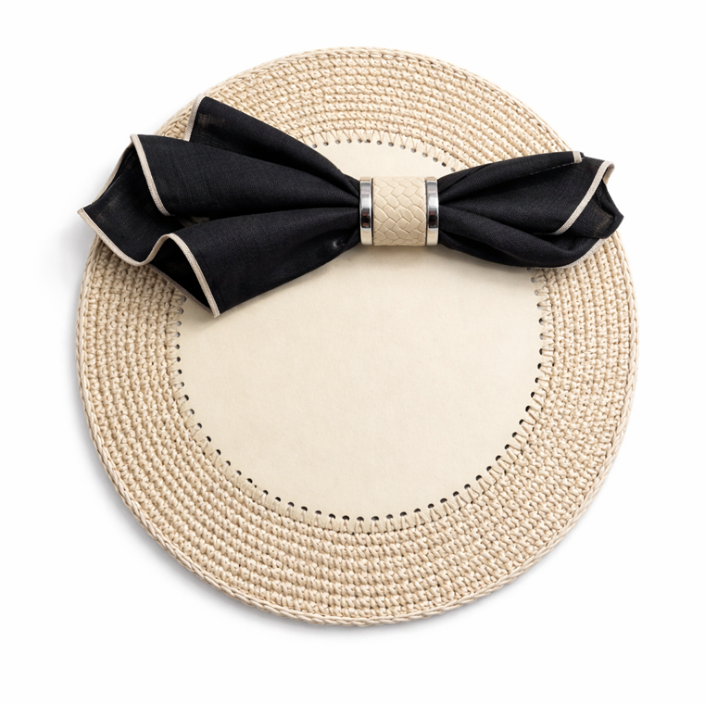 Cream 36 cm placemat, black napkin in a woven leather ring banded with steel on the leather centre