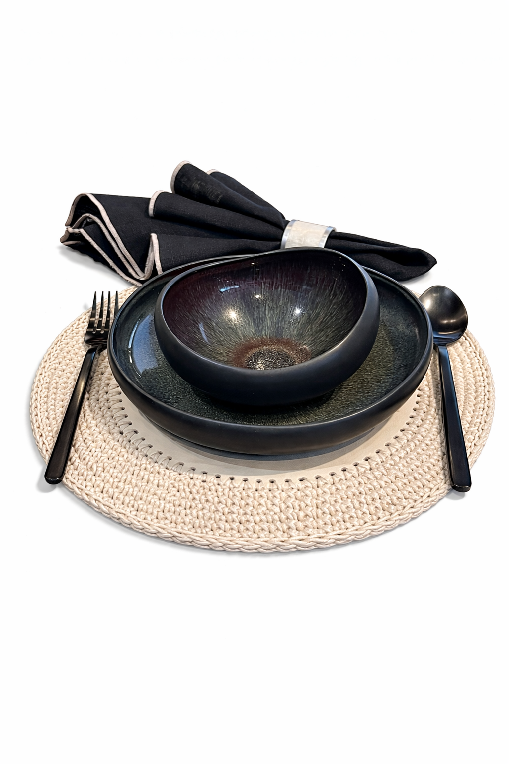 Dark glazed bowl and plate with black cutlery on the 36 cm cream placemat, napkin behind