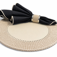 Cream round placemat, leather centre bare, black napkin resting on the raised cord border