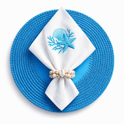 Blue 36 cm placemat, white napkin embroidered with shell and starfish in a shell ring on top