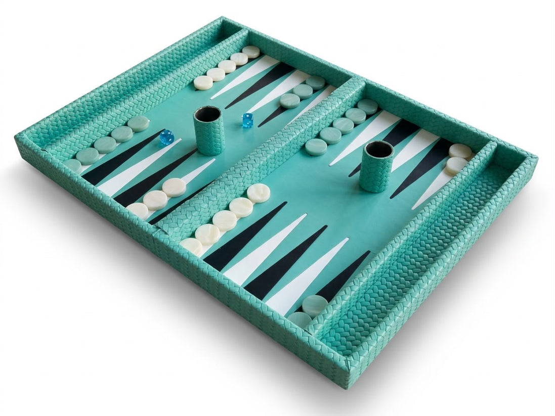 Turquoise woven leather backgammon board open, checkers laid out and two leather dice cups in play