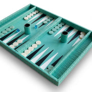 Close angle across the backgammon bed, black and white points set inside turquoise woven leather 3 cm walls