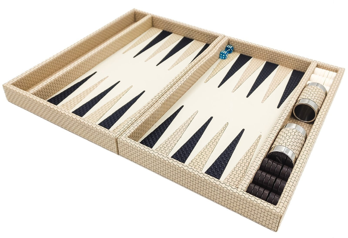 Cream woven leather backgammon set open flat, navy and cream points, dice cups and dark checkers in the side rail