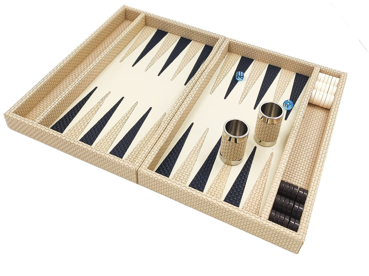 Cream woven leather backgammon board angled, two leather-covered dice cups standing on the playing field