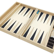The folding backgammon board in cream woven leather opened flat, dice cups resting in the side rail