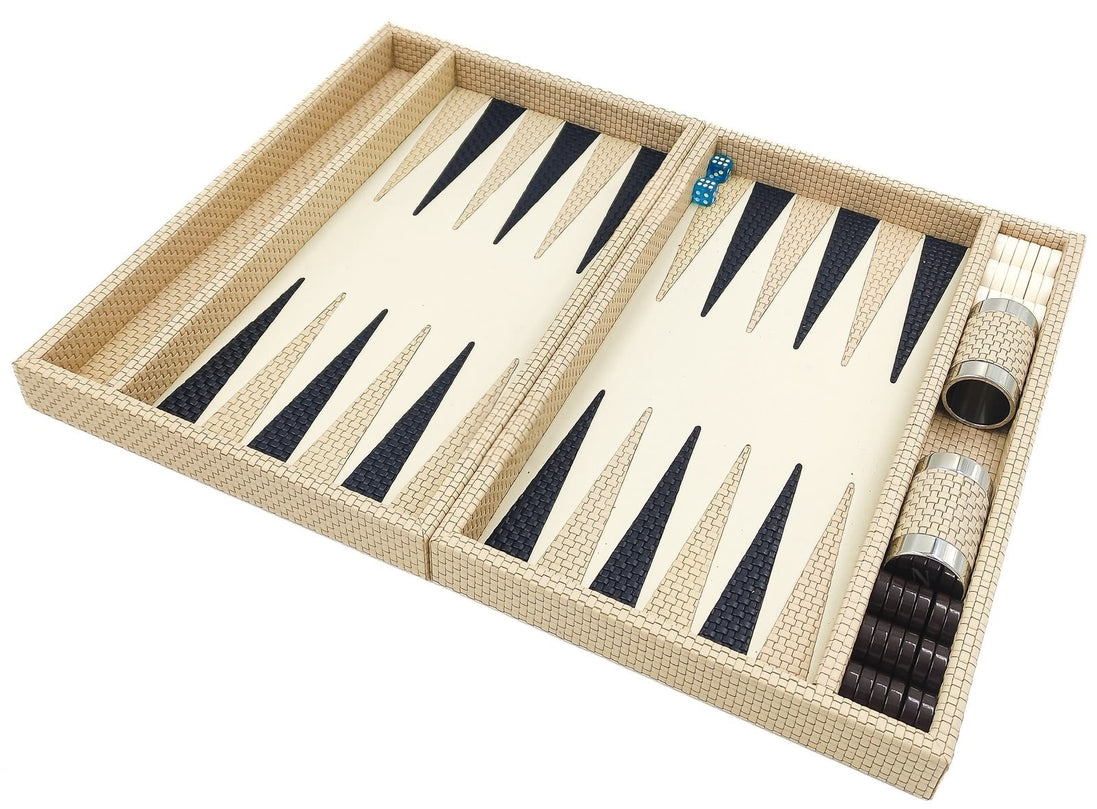 The folding backgammon board in cream woven leather opened flat, dice cups resting in the side rail