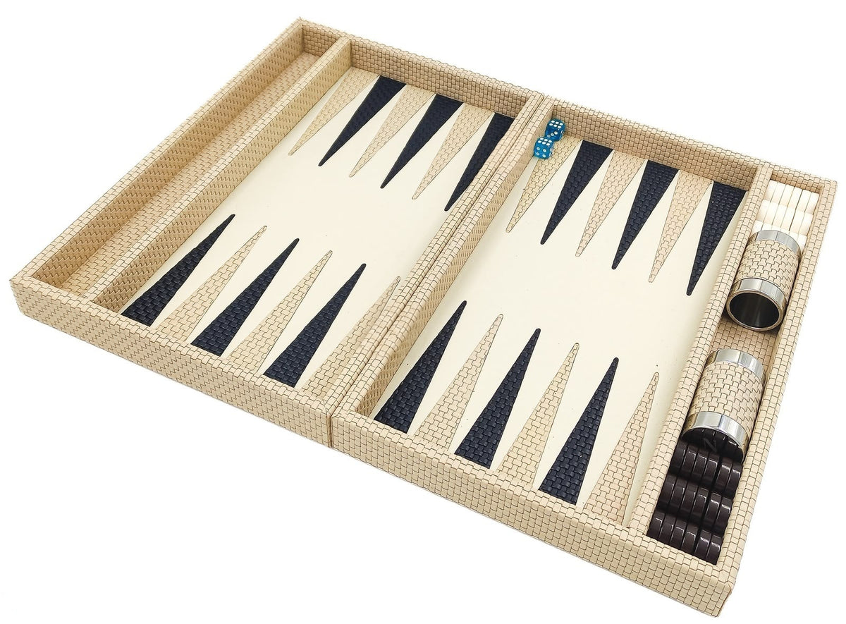 The folding backgammon board in cream woven leather opened flat, dice cups resting in the side rail