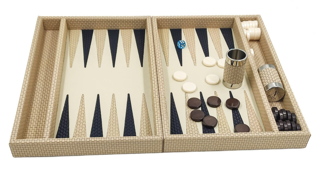 Cream leather backgammon set seen from the front, cream and dark checkers laid out beside a leather dice cup