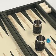 Forest green leather backgammon set angled, dice cups and blue dice on the ivory playing field