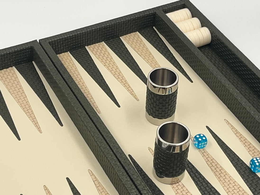Forest green leather backgammon set angled, dice cups and blue dice on the ivory playing field