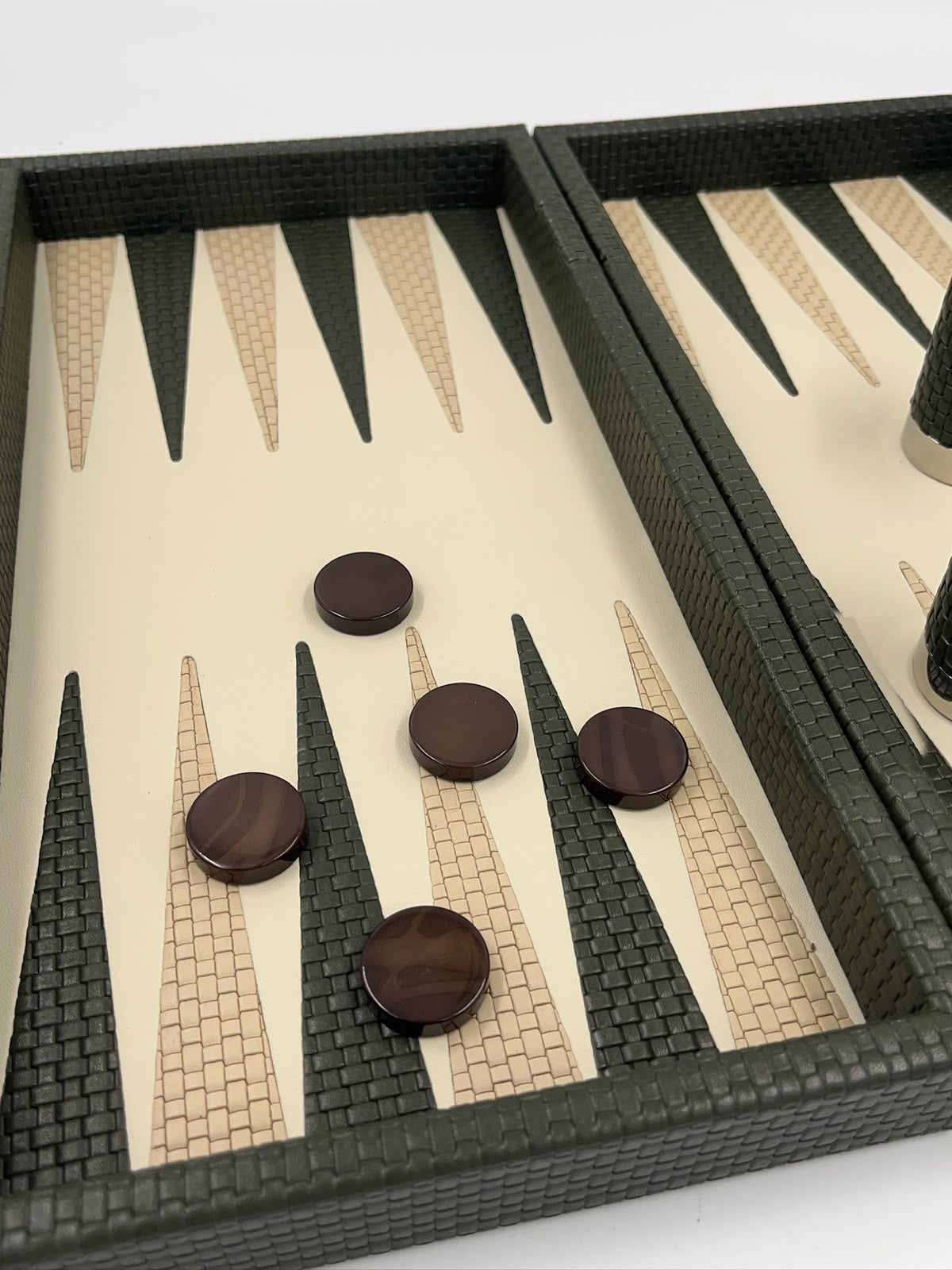 Close-up of the forest green board, dark brown checkers on green and beige woven leather points