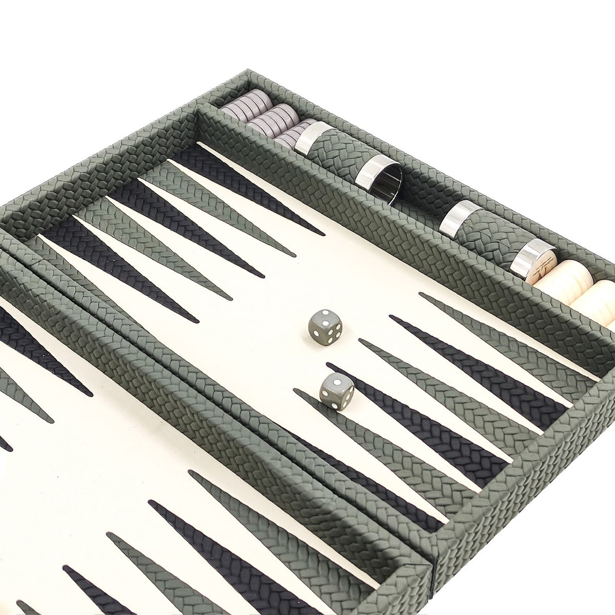 Sage green woven leather backgammon board angled, grey dice and checkers stacked in the side rail