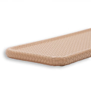 Beige slim tray, raking light across the woven leather showing the depth of each cell
