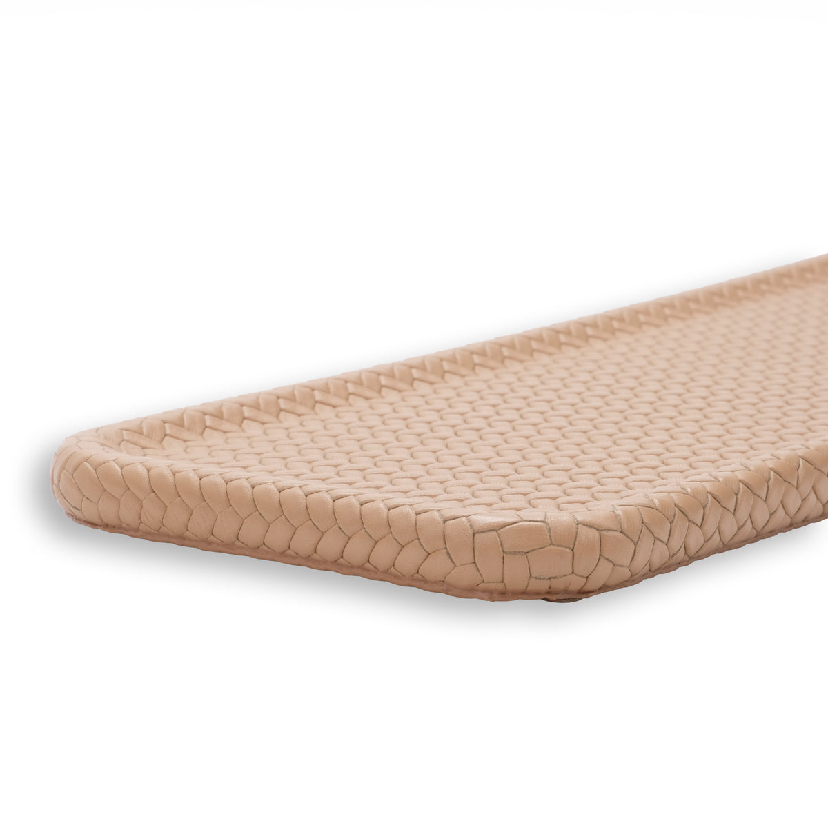 Beige slim tray, raking light across the woven leather showing the depth of each cell