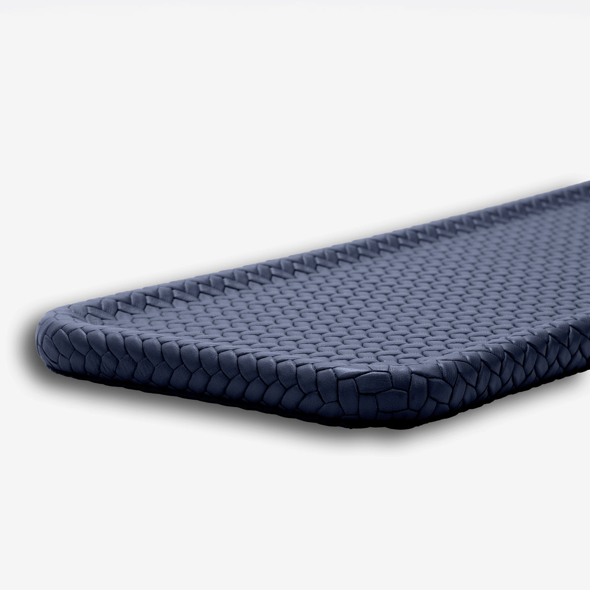Navy blue slim tray, close on the rounded corner and the tight plaited edge that wraps it