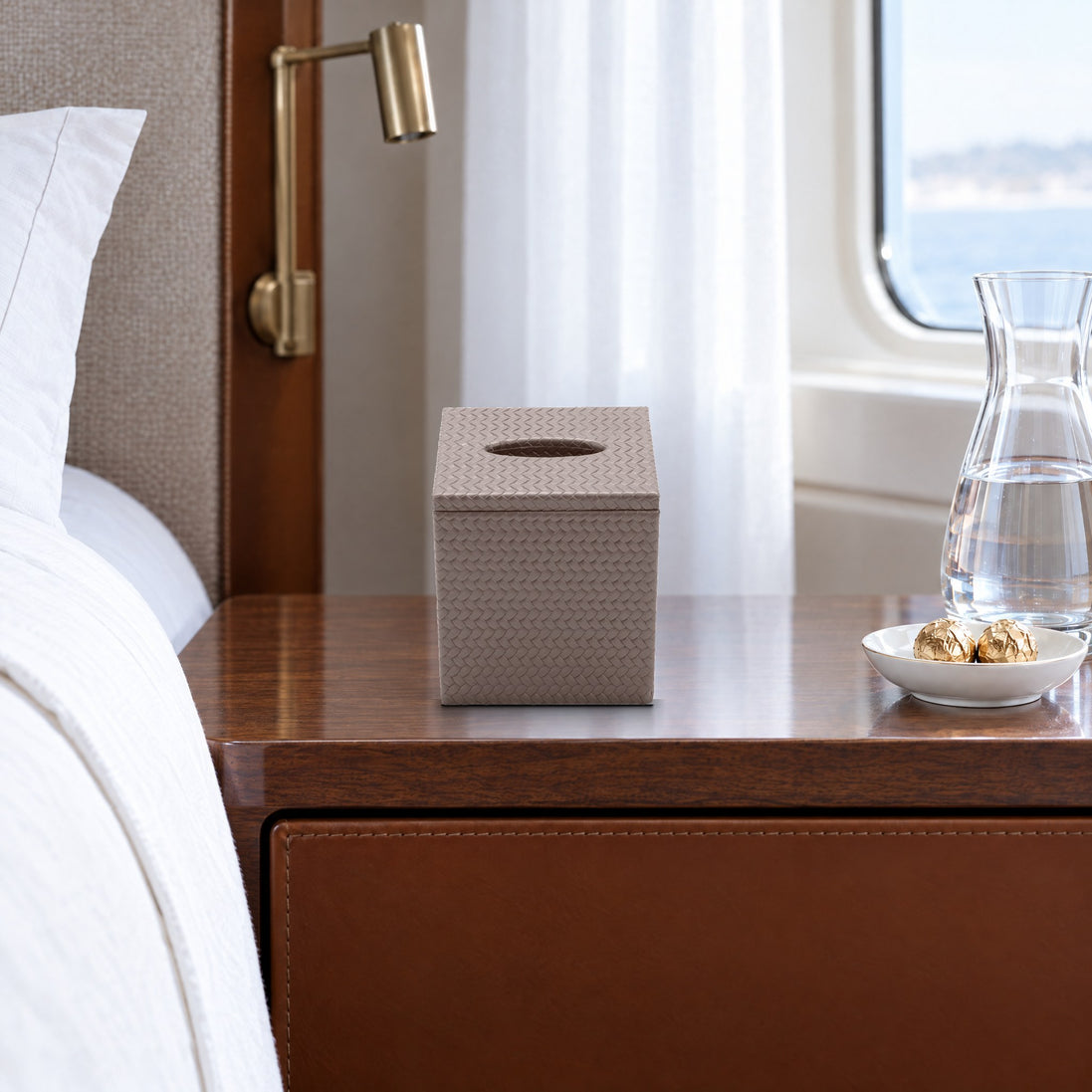 Upright Woven Leather Tissue Box Cover, mink — on a walnut bedside table in a VIP guest cabin