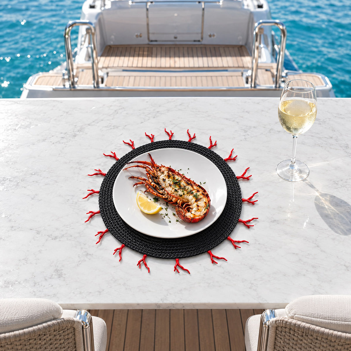 Round Woven Placemat with Red Coral-Shaped Edge — lobster lunch at the table on the swim platform, the sea at eye level
